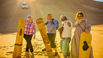 Abu Dhabi: Desert Safari with BBQ Dinner, Camel Ride & Sandboarding